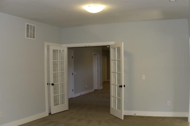 empty room with carpet floors and french doors