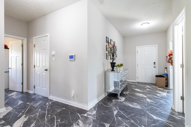 foyer entrance featuring a textured ceiling