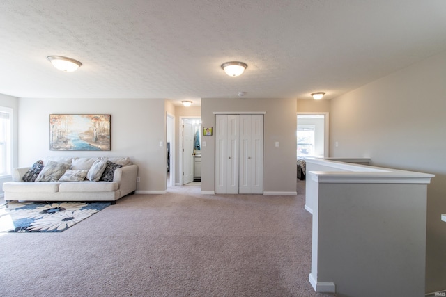 living room with light colored carpet and a textured ceiling