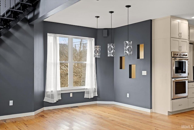 unfurnished dining area featuring light hardwood / wood-style floors