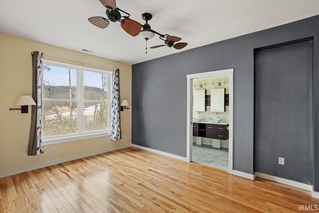 spare room with hardwood / wood-style floors and ceiling fan