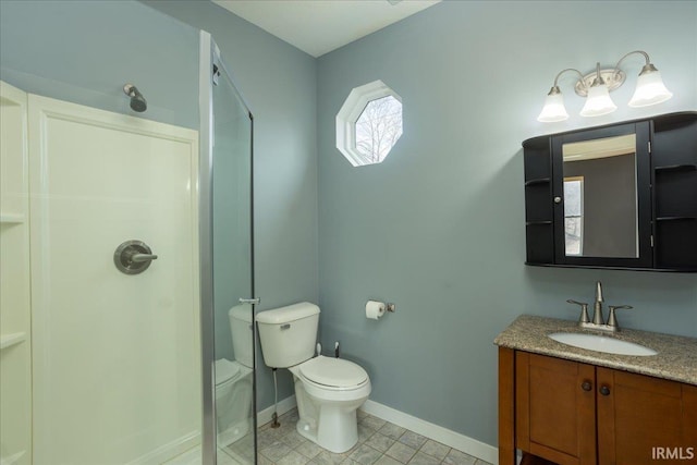 bathroom with vanity, toilet, and walk in shower