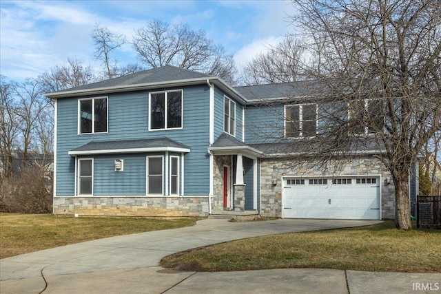 view of front of house with a garage and a front lawn