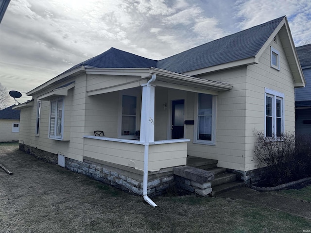 view of side of property with a porch