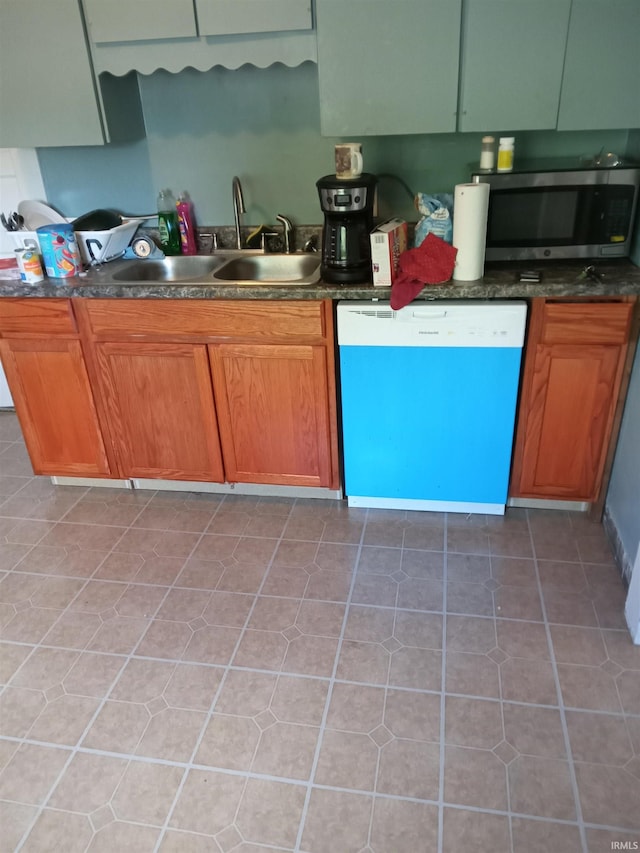 kitchen featuring tile patterned flooring, dishwasher, and sink