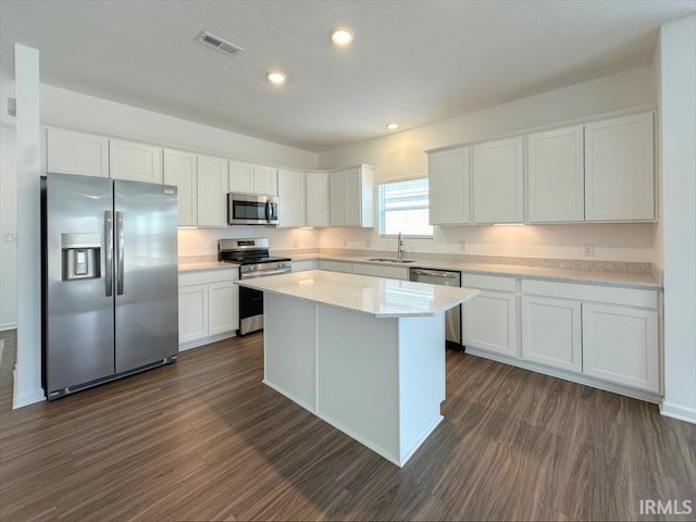 kitchen featuring white cabinetry, stainless steel appliances, and a center island