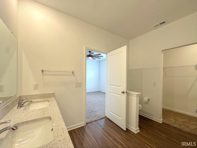 bathroom featuring hardwood / wood-style flooring, vanity, and toilet