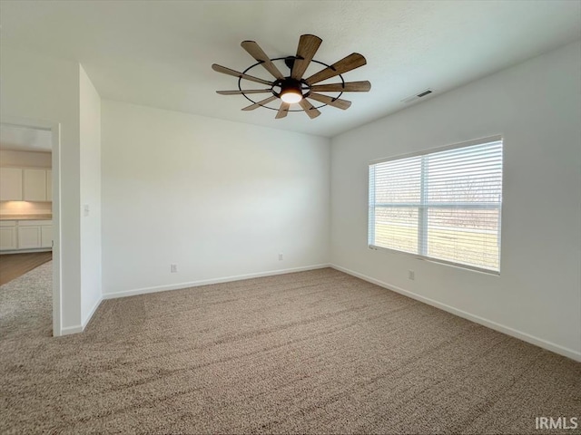 empty room with ceiling fan and carpet flooring