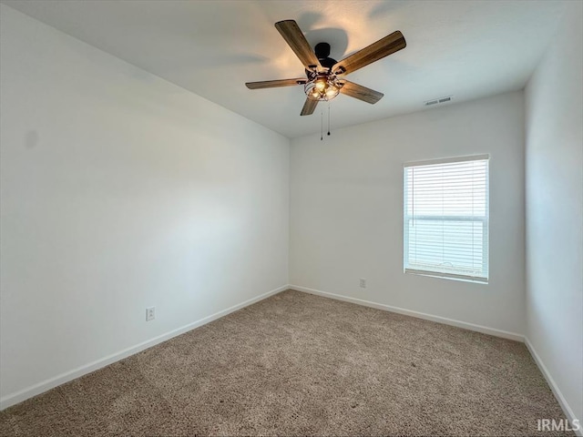 empty room featuring ceiling fan and carpet