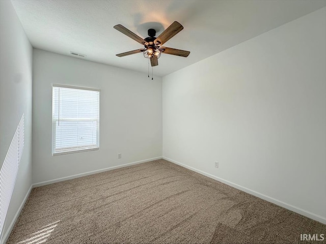 carpeted empty room with ceiling fan