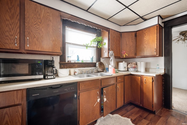 kitchen featuring sink, backsplash, a paneled ceiling, dishwasher, and dark wood-type flooring