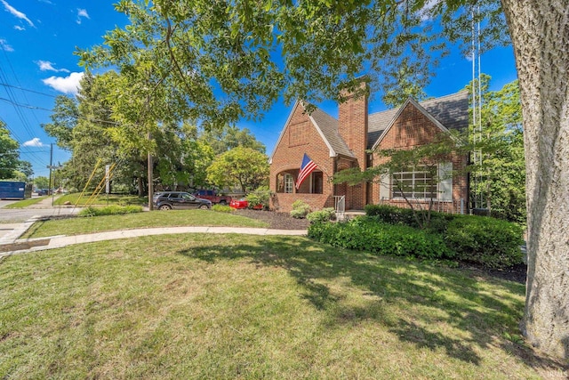 tudor-style house with a front lawn