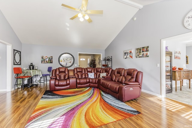 living room featuring hardwood / wood-style floors, high vaulted ceiling, and ceiling fan