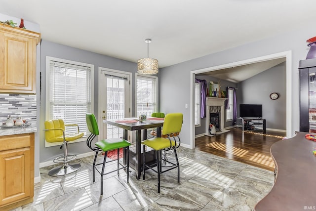 dining area featuring lofted ceiling