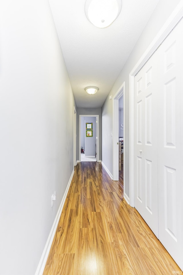 hallway with wood-type flooring