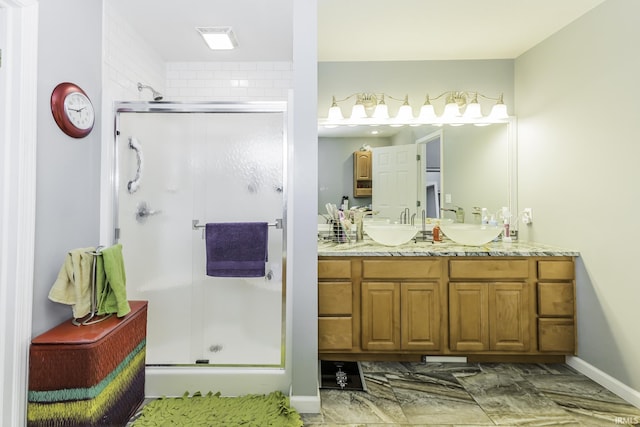 bathroom with vanity and a shower with door