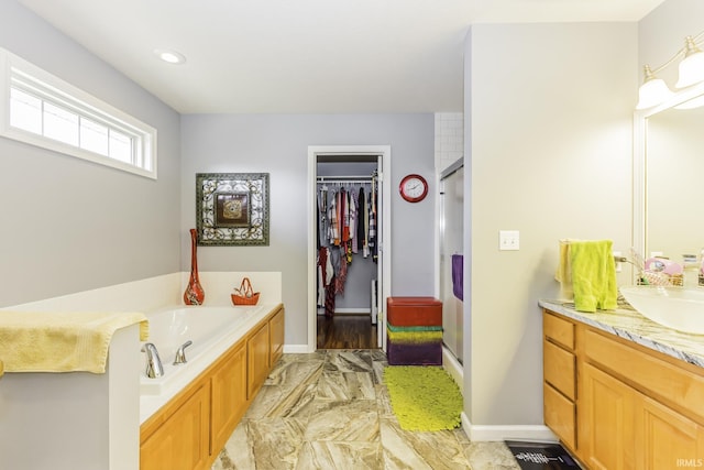 bathroom featuring vanity and separate shower and tub