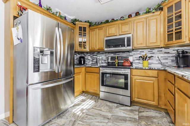 kitchen with tasteful backsplash, light stone countertops, appliances with stainless steel finishes, and a textured ceiling