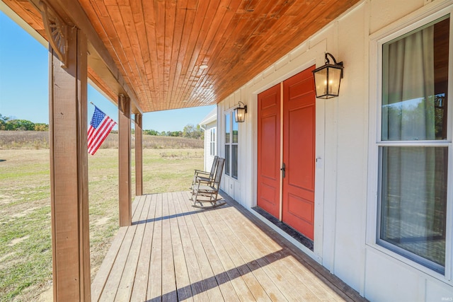 deck with a lawn and covered porch