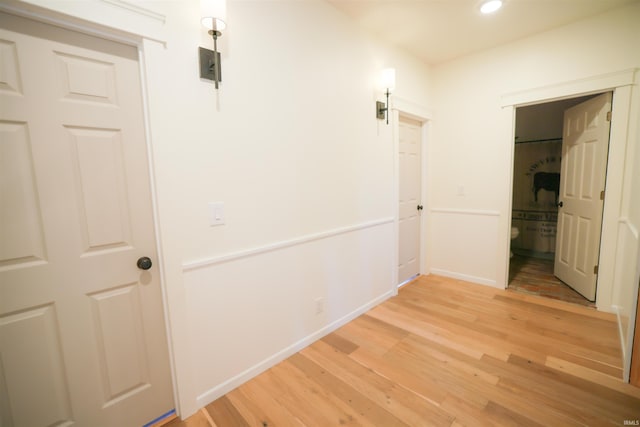 hallway with light hardwood / wood-style flooring