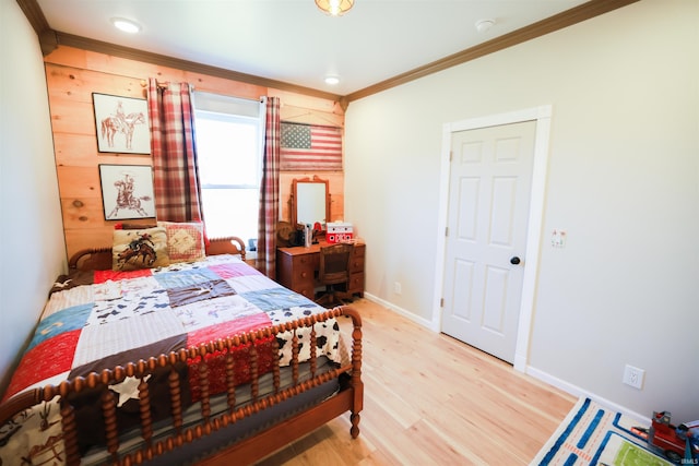 bedroom with ornamental molding and light hardwood / wood-style flooring