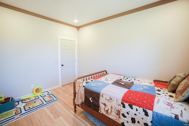 bedroom with hardwood / wood-style floors and crown molding