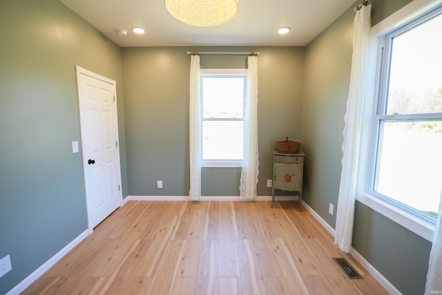 spare room with light hardwood / wood-style floors