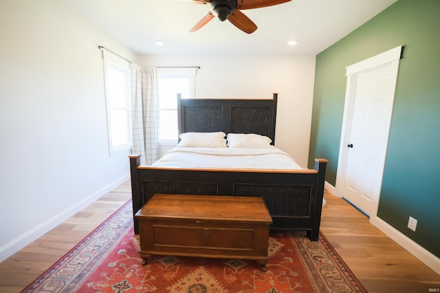 bedroom with wood-type flooring and ceiling fan