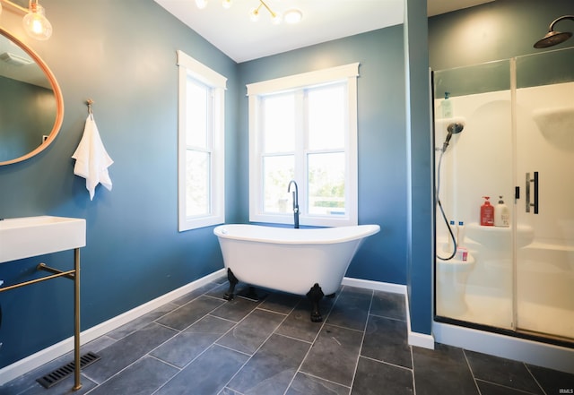 bathroom featuring tile patterned flooring and shower with separate bathtub