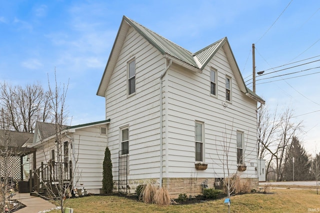 view of property exterior with a yard