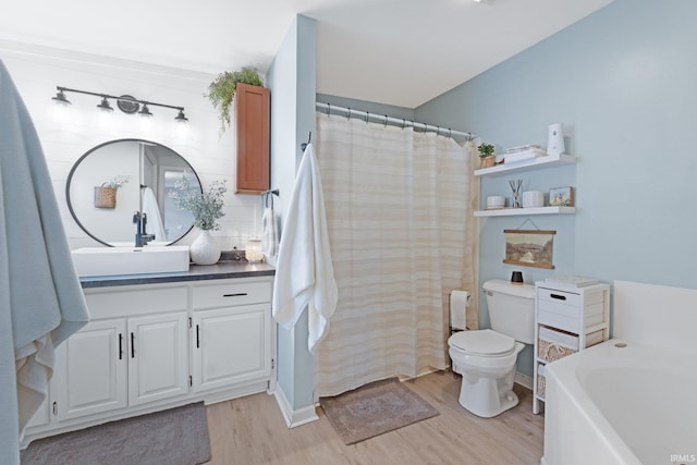 full bathroom with vanity, hardwood / wood-style flooring, independent shower and bath, and toilet