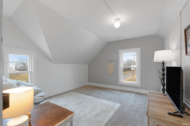 interior space with vaulted ceiling and carpet floors