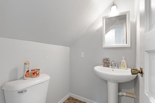 bathroom featuring vaulted ceiling and toilet