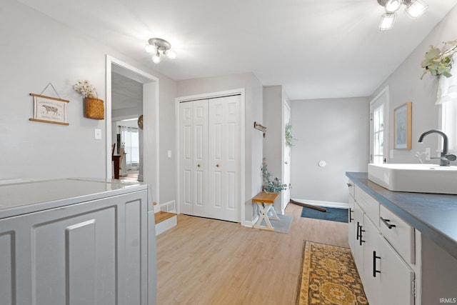 bathroom with hardwood / wood-style flooring and sink