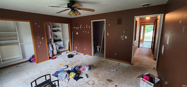 interior space with ceiling fan