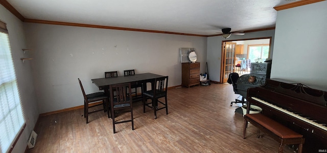 dining room with ornamental molding, ceiling fan, and light wood-type flooring