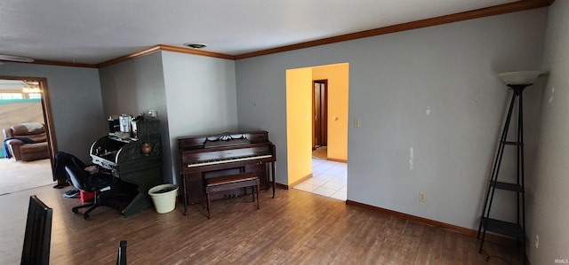 miscellaneous room featuring ornamental molding and light hardwood / wood-style floors