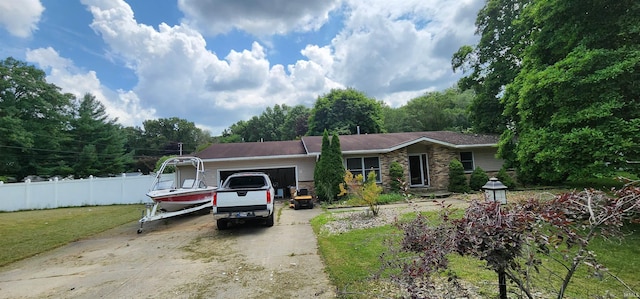 ranch-style house with a garage and a front lawn