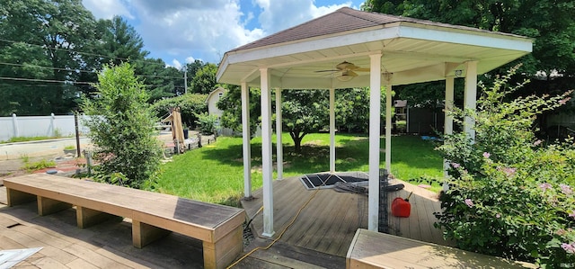 wooden deck featuring a yard, a gazebo, and ceiling fan