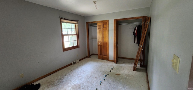 unfurnished bedroom featuring two closets