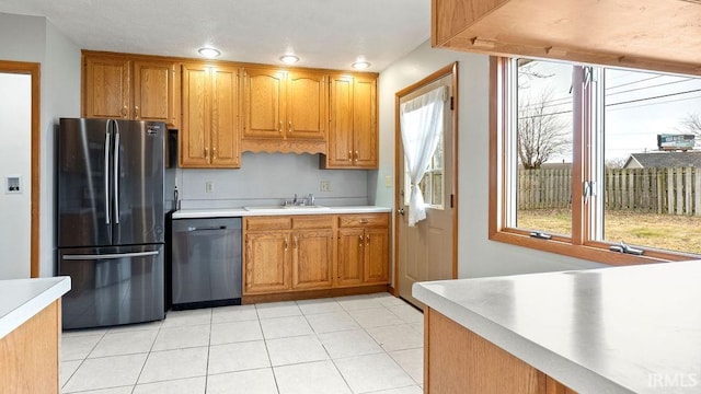 kitchen with sink, light tile patterned floors, and stainless steel appliances