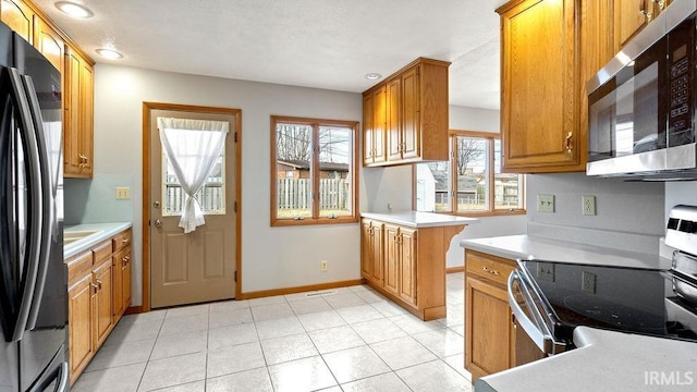 kitchen featuring stainless steel appliances and light tile patterned floors