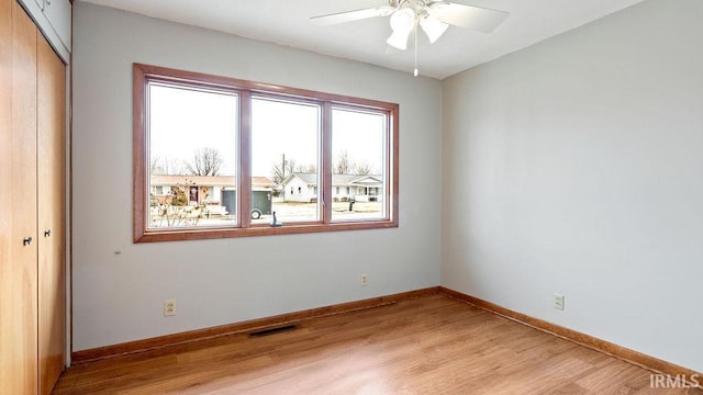 spare room featuring ceiling fan and light hardwood / wood-style floors