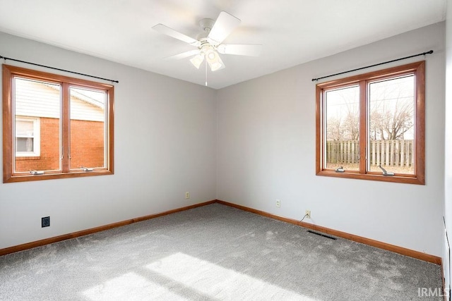 spare room featuring carpet floors and ceiling fan