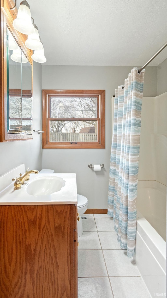 full bathroom with vanity, shower / bathtub combination with curtain, tile patterned floors, and toilet