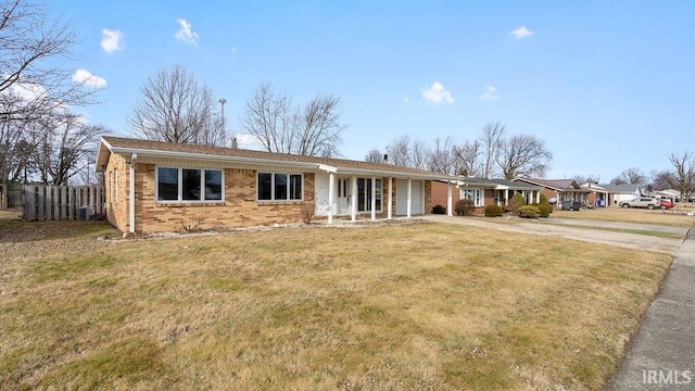 ranch-style house with central air condition unit and a front lawn