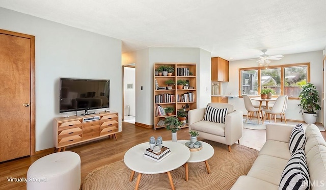 living room with hardwood / wood-style flooring and ceiling fan