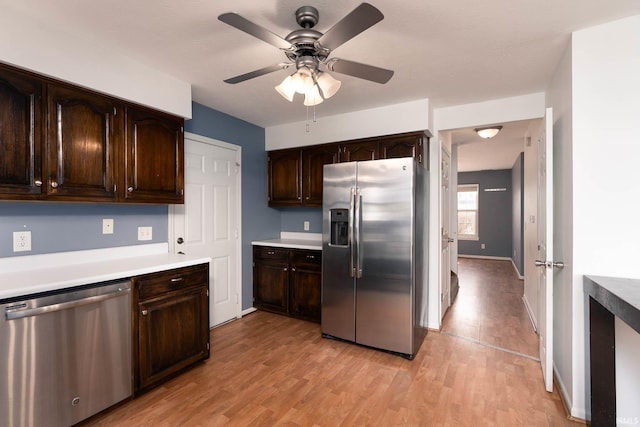 kitchen featuring ceiling fan, dark brown cabinetry, stainless steel appliances, and light hardwood / wood-style flooring