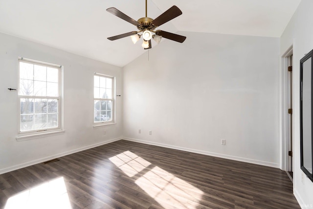 empty room featuring ceiling fan, dark hardwood / wood-style floors, and vaulted ceiling