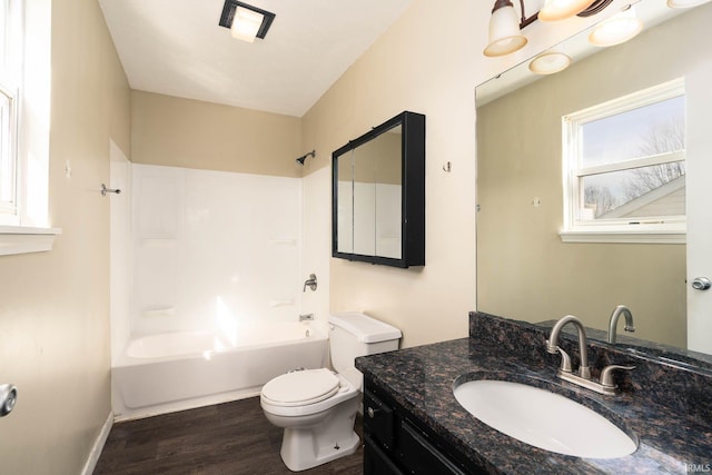 full bathroom featuring hardwood / wood-style flooring, toilet, vanity, and  shower combination